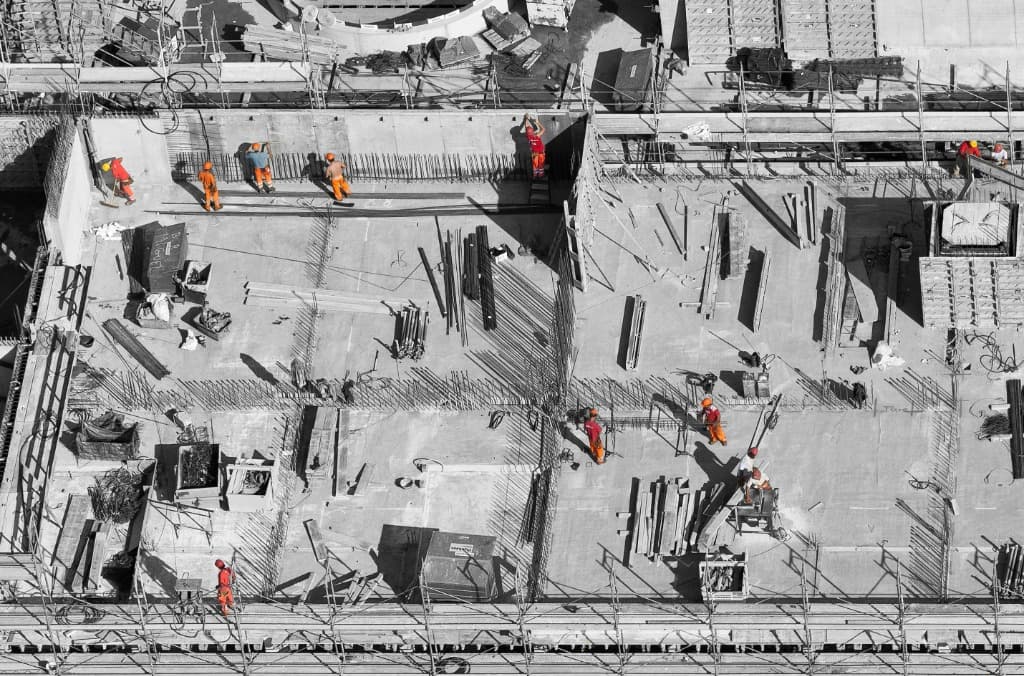 Aerial view of construction site with workers and reinforcement