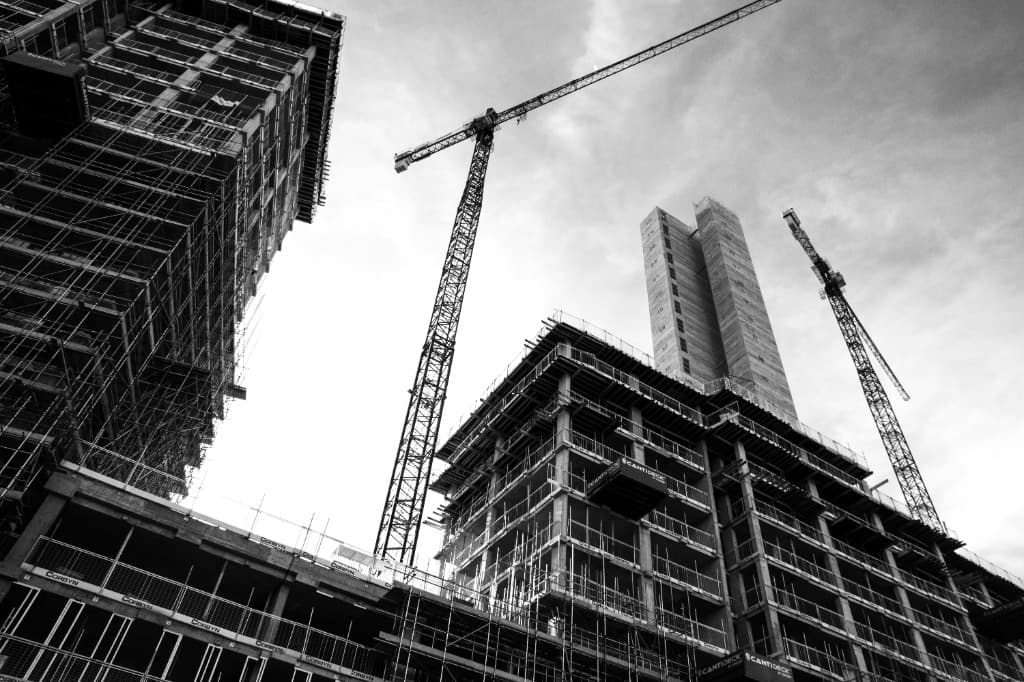 High-rise building under construction with tower cranes